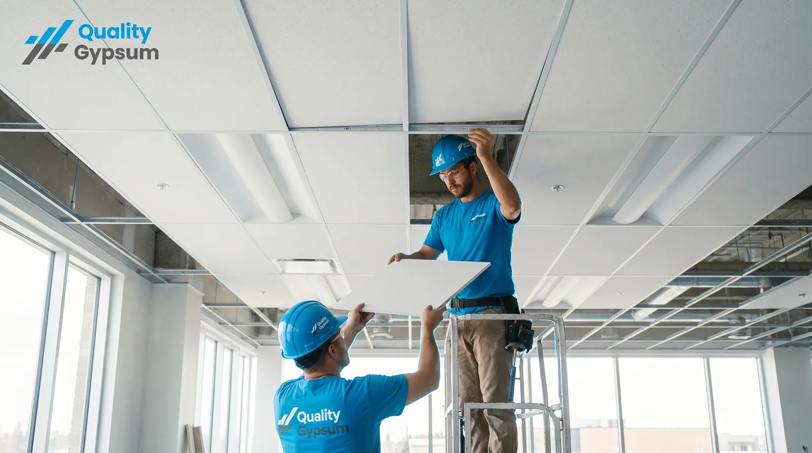 Modern suspended T-bar acoustic ceiling grid with recessed lighting in a Calgary office