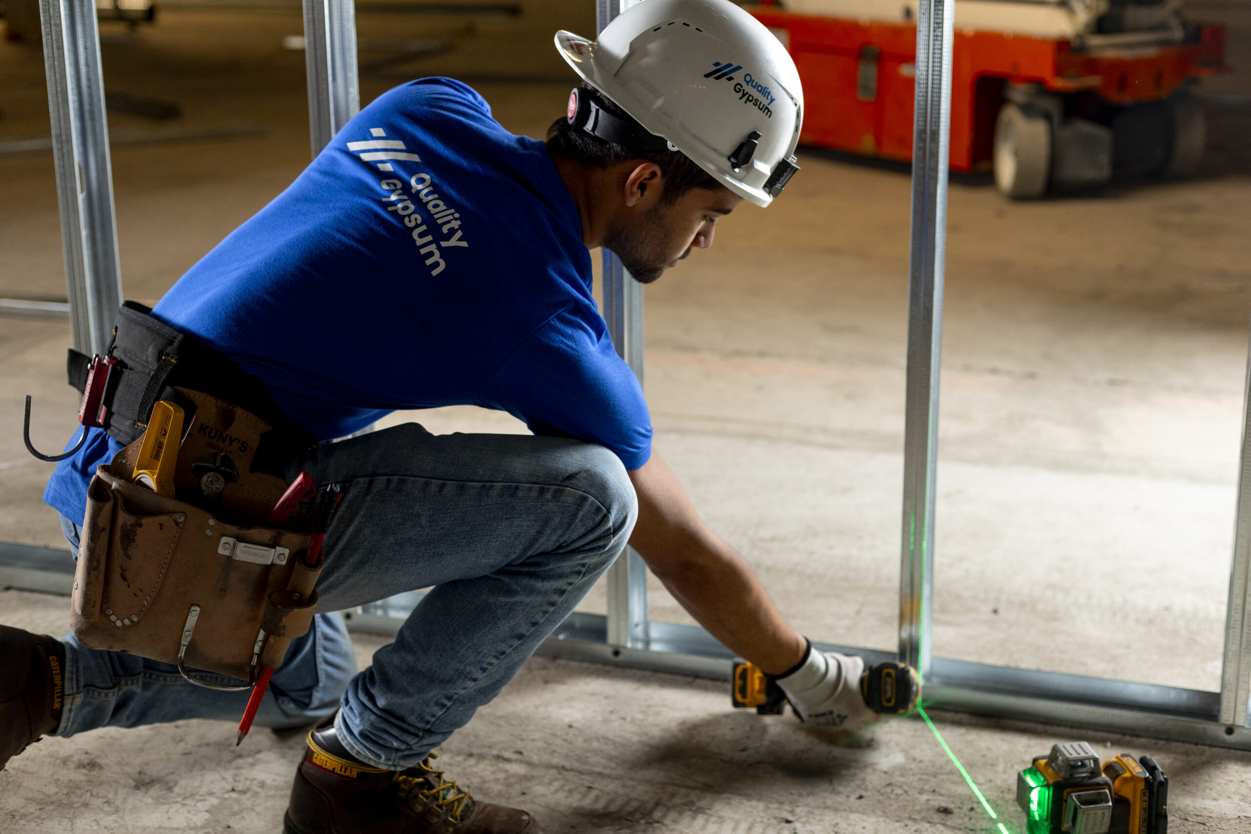 Steel stud framer screwing a stud